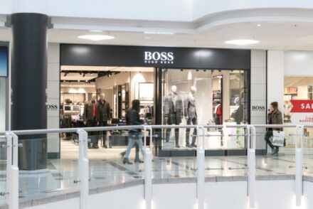 Shop front with clothes visible through the window.