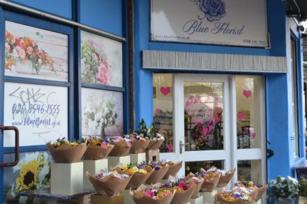 image of bouqets of flowers in front of blue florist shop