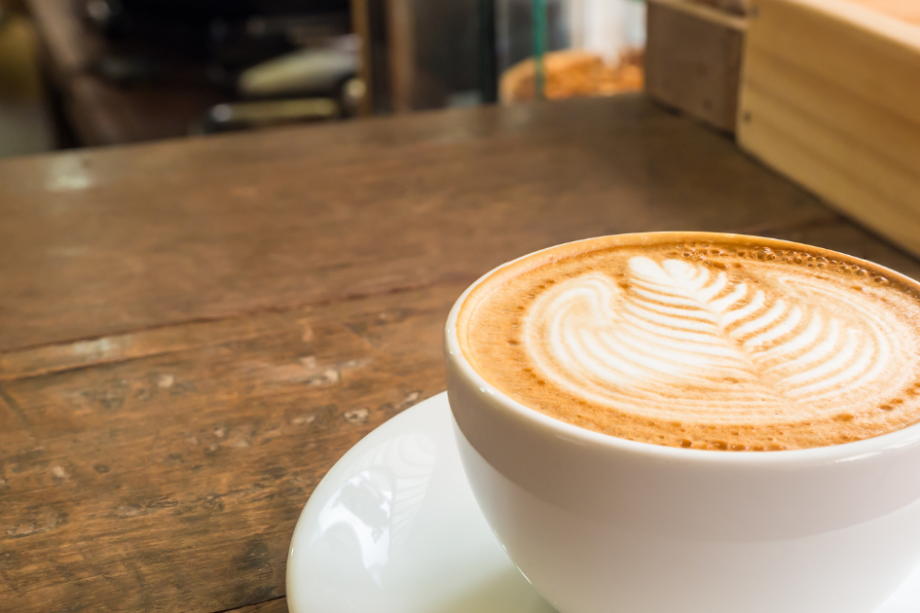 Image inside coffeeshop of counter and person working