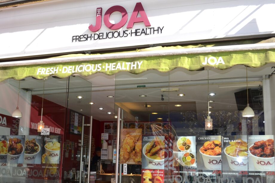 Joa's shop front with posters of the food