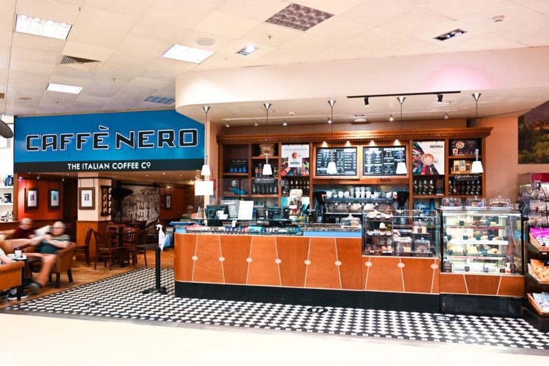 An image of Caffe Nero’s coffee and a croissant on a table inside the coffee shop