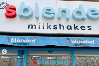 An image in front of Sblended shop with signs and blue doors
