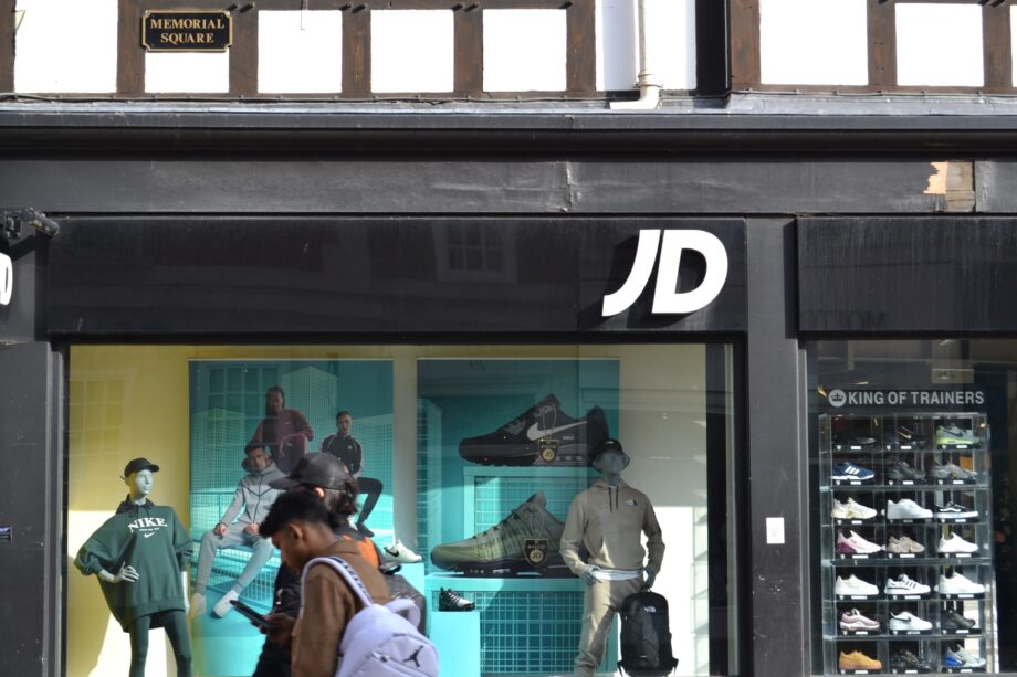 image of JD Sport shop front with trainers and mannequins wearing sportswear