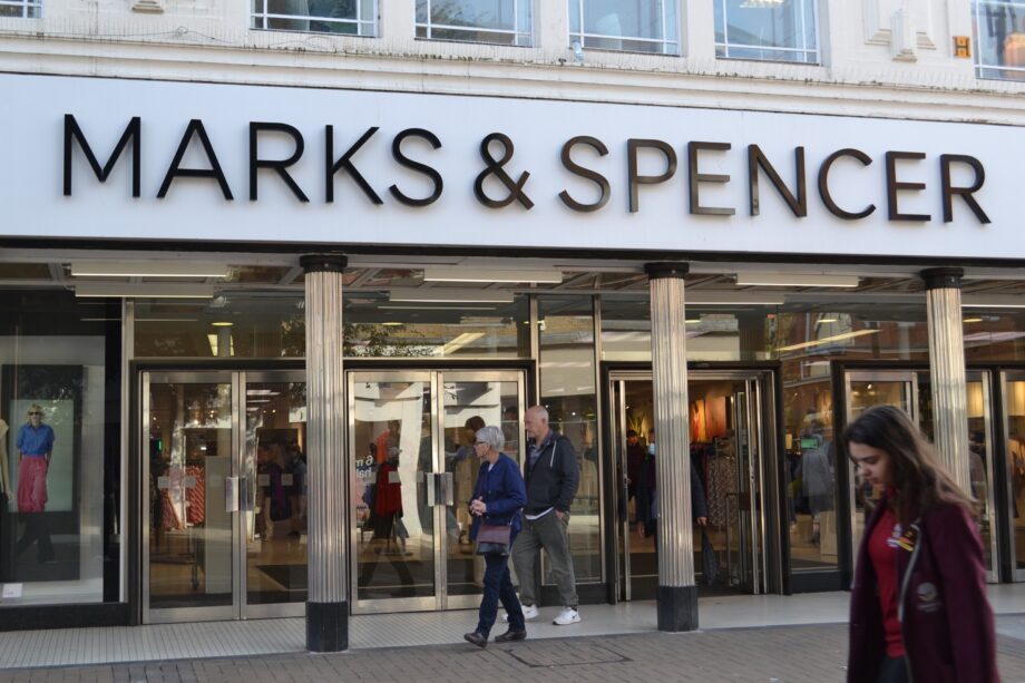 Photo of outside M&S with signage and doors and shoppers entering the store