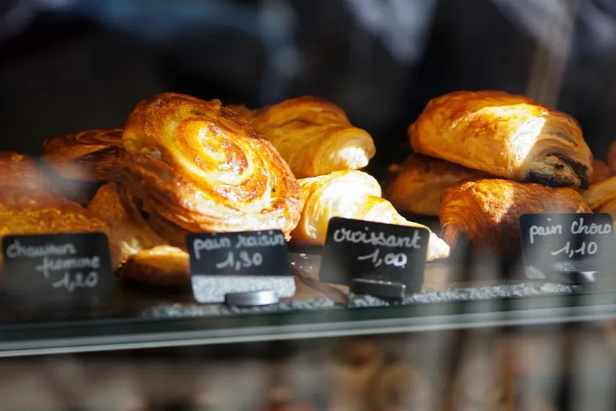 Image of croissant on a shelf at a bakery