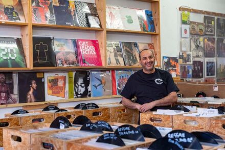 Man in record shop smiling