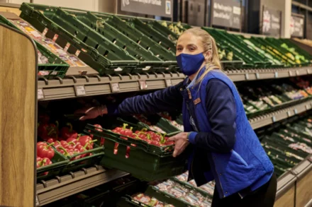 Aldi Colleague stacking shelves