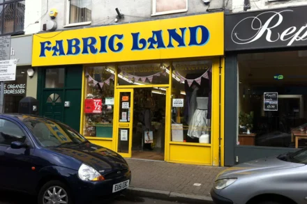 Shop frontage with logo and bunting in the windows.
