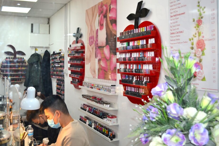 image of the inside of a nail salon with nails product at the back