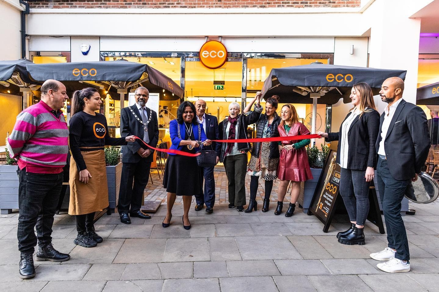 image of eco team on their launch day in front of eco restaurant in kingston