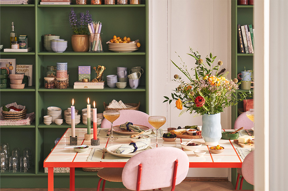 A modern Nordic-style dining room with a set table.